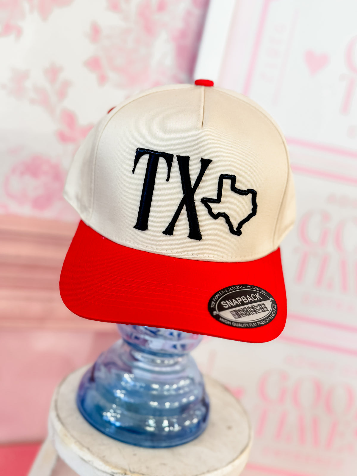 TX hat with red bill and black thread